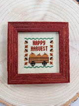 Fall Happy Harvest cross stitch framed, flat top-down view showing full design