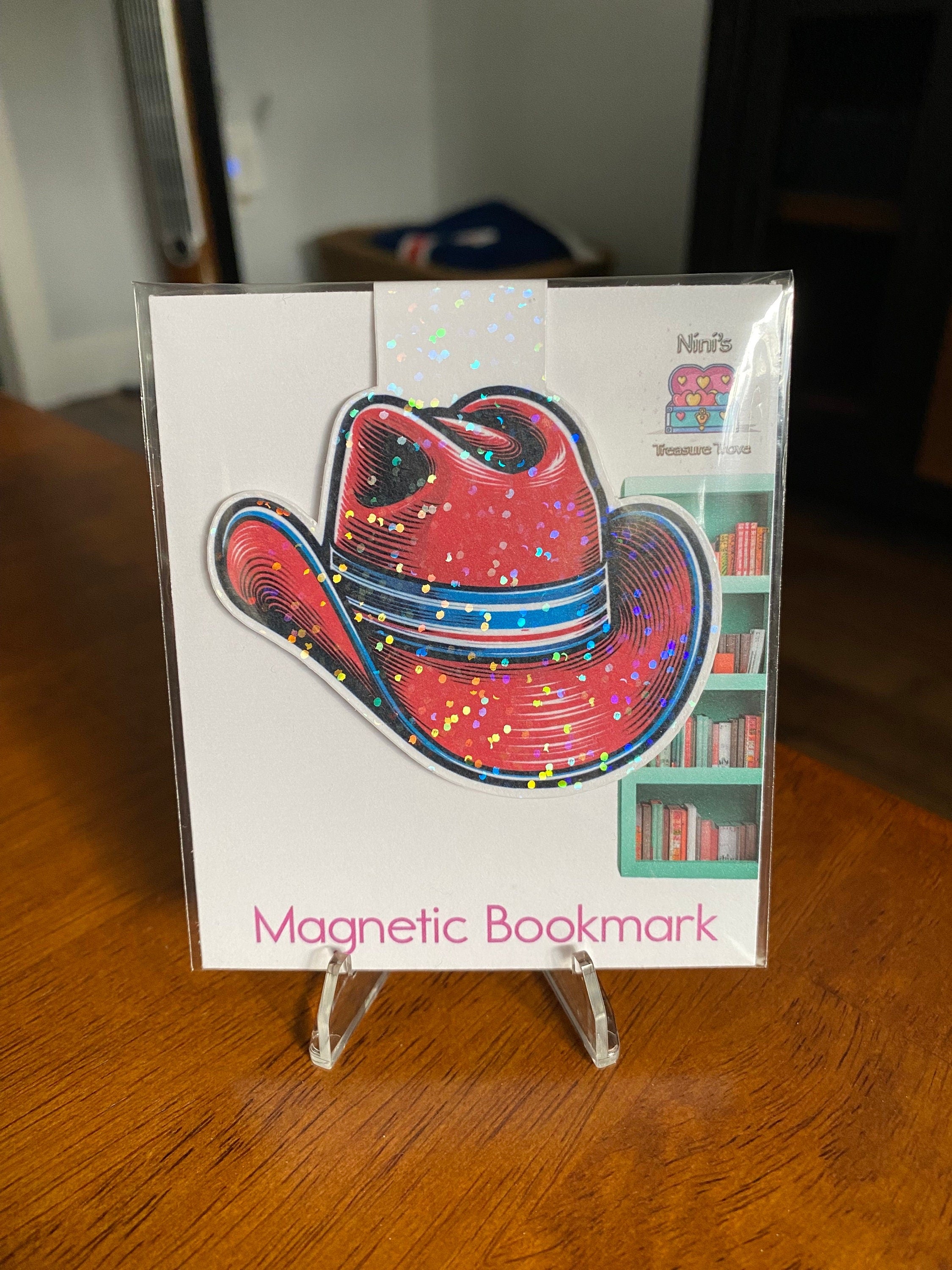Holographic red cowboy hat magnetic bookmark on a Nini's Treasure Trove product card