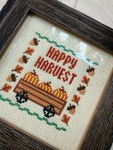 Hand-Stitched Fall Happy Harvest cross stitch in Dark Walnut frame, angled view