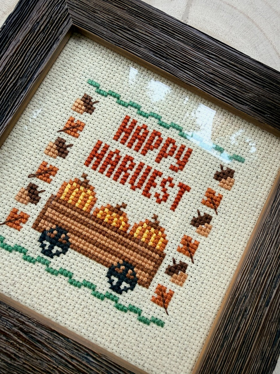 Hand-Stitched Fall Happy Harvest cross stitch in Dark Walnut frame, angled view