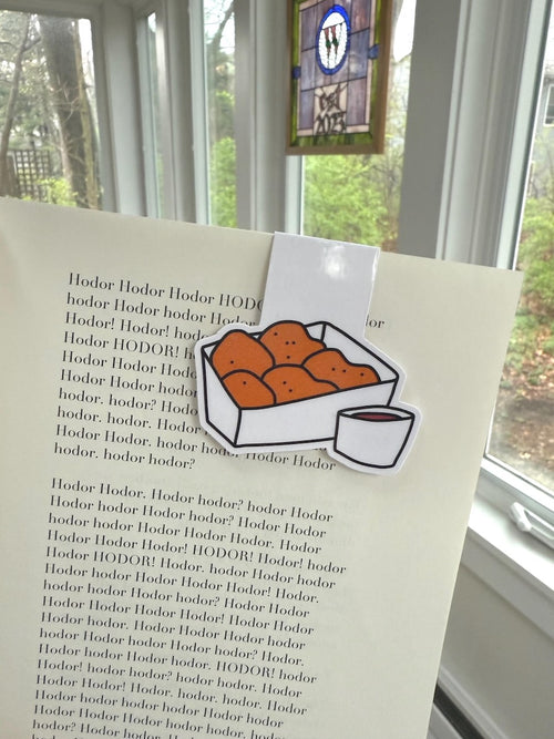 Chicken Nuggets Magnetic Bookmark clipped onto a book page, close up of nugget box and dipping sauce illustration