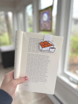 Chicken Nuggets Magnetic Bookmark held in a hand marking a page in an open book