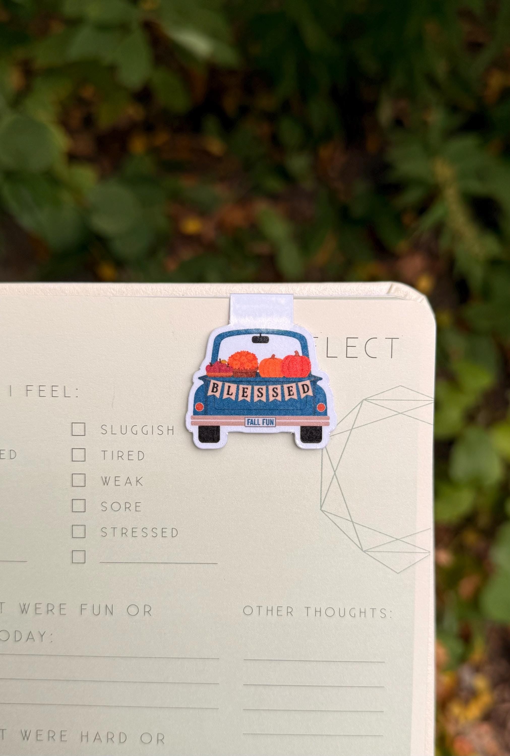 Blessed fall pumpkin truck Mini-Marks bookmark clipped to a notebook page