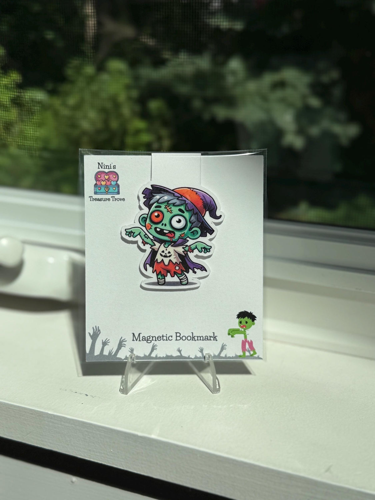 Halloween zombie kid magnetic bookmark on a Nini's Treasure Trove product card