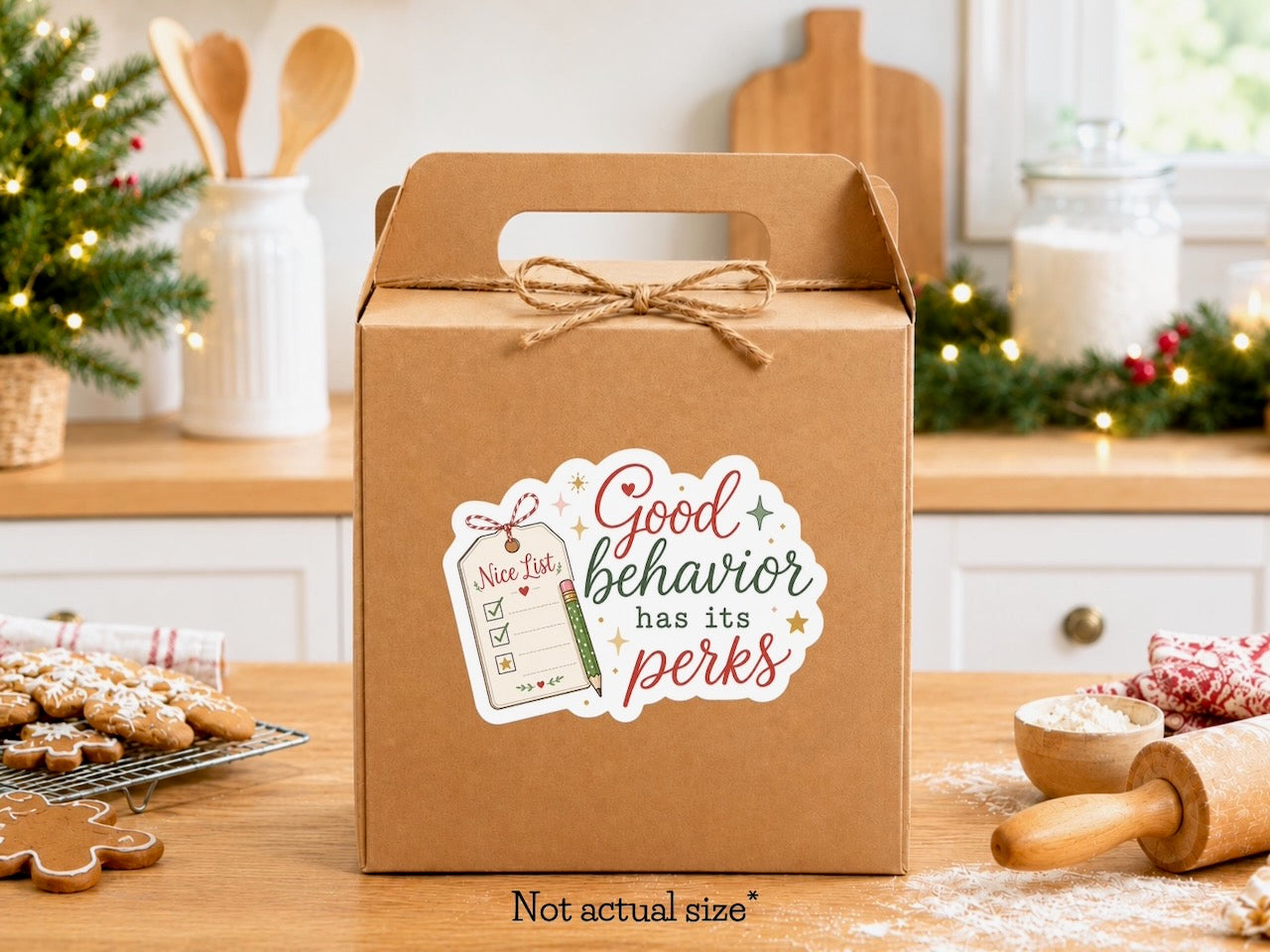 Good behavior has its perks Christmas sticker with a Nice List gift tag on a kraft gift box, gingerbread cookies and holiday greenery