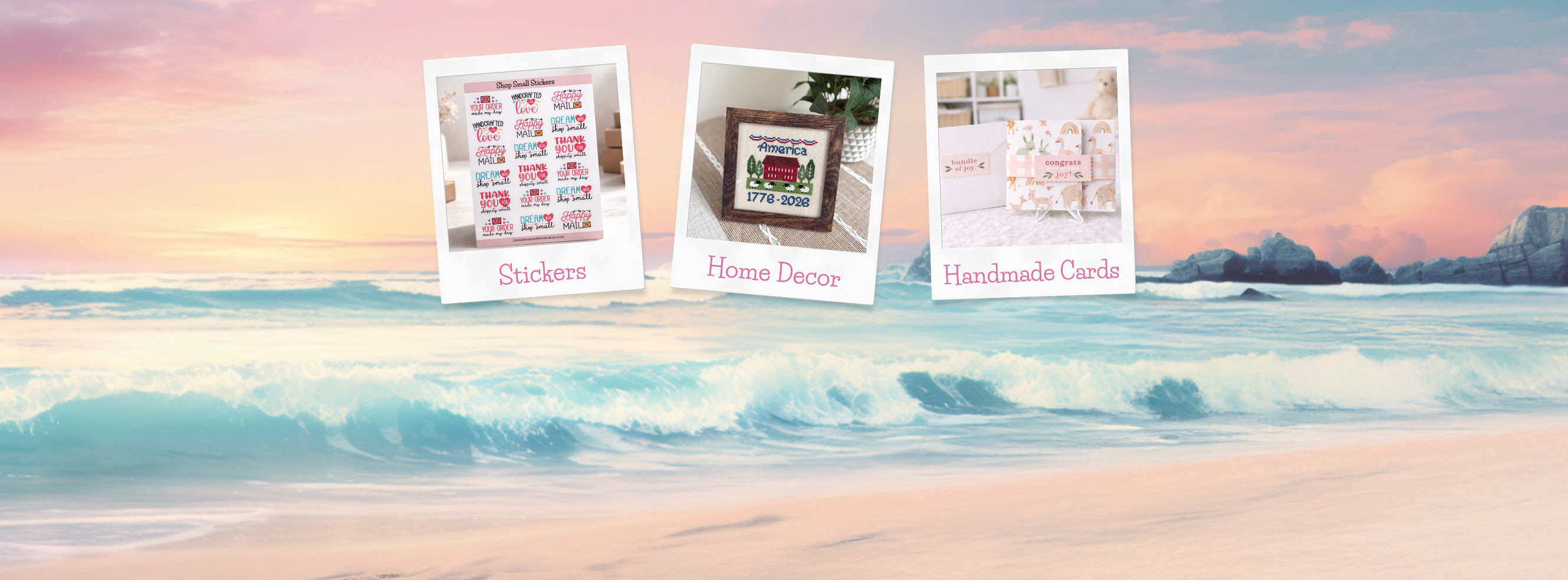Handmade stickers, cross stitch home decor, and handmade cards on a pastel beach