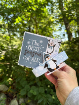 Penguin card opened to pop-up gift bag