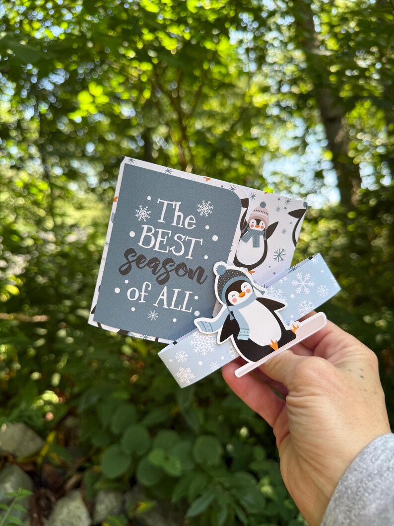 Penguin card opened to pop-up gift bag