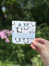 Penguin card opened to pop-up gift bag