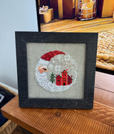 Framed cross-stitch, Santa Christmas Village, distressed black frame