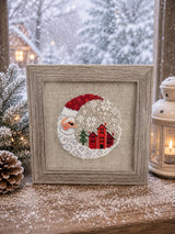 Framed cross-stitch, Santa Christmas Village, distressed brown frame