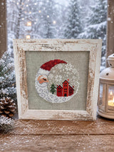 Framed cross-stitch, Santa Christmas Village, distressed white frame