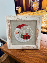 Framed cross-stitch, Santa Christmas Village, distressed white frame detail